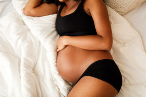 pregnant woman on her side in bed 