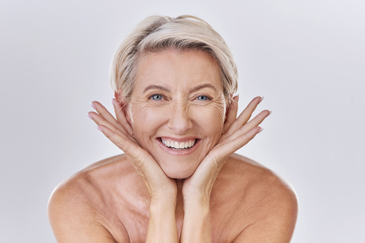 smiling woman with hands on chin and jawline