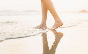feet in the ocean at shore