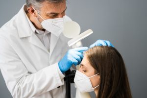 doctor inspecting a womans head