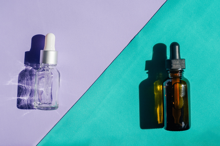 Face serum on purple turquoise background above