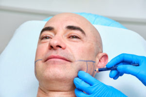 man being prepped for injections for treating teeth grinding